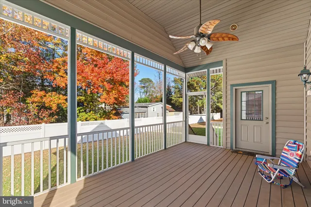 a view of a porch with furniture and a yard