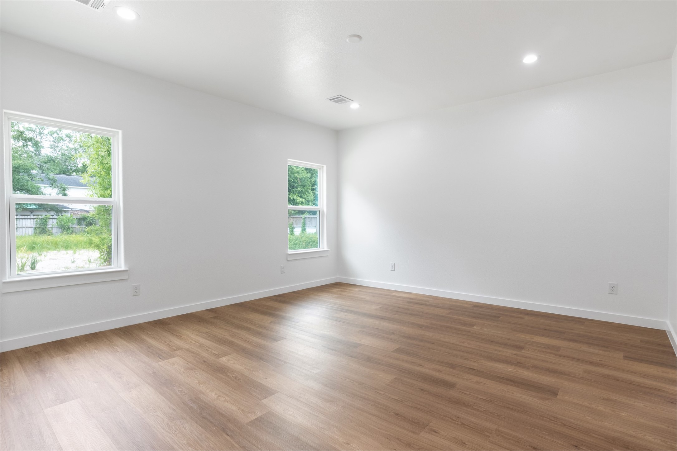 14390 Half Circle Splendora, TX 77372 - Photo 12 of 27 an empty room with wooden floor and windows