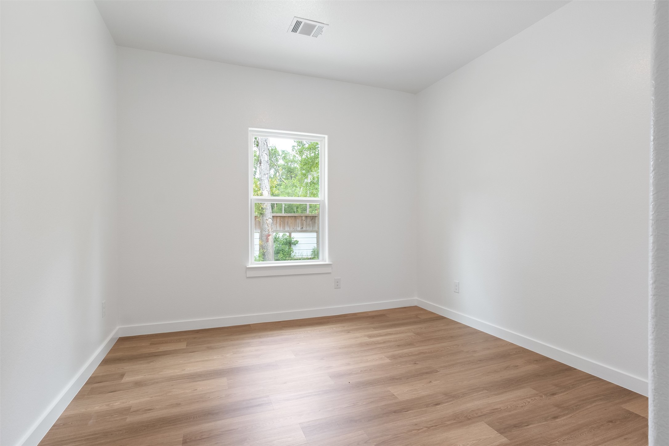 14390 Half Circle Splendora, TX 77372 - Photo 17 of 27 an empty room with wooden floor and windows