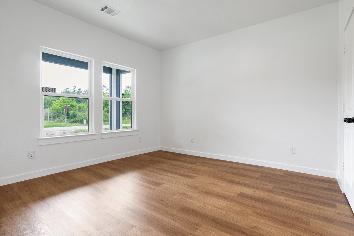 14390 Half Circle Splendora, TX 77372 - Photo 19 of 27 an empty room with wooden floor and windows