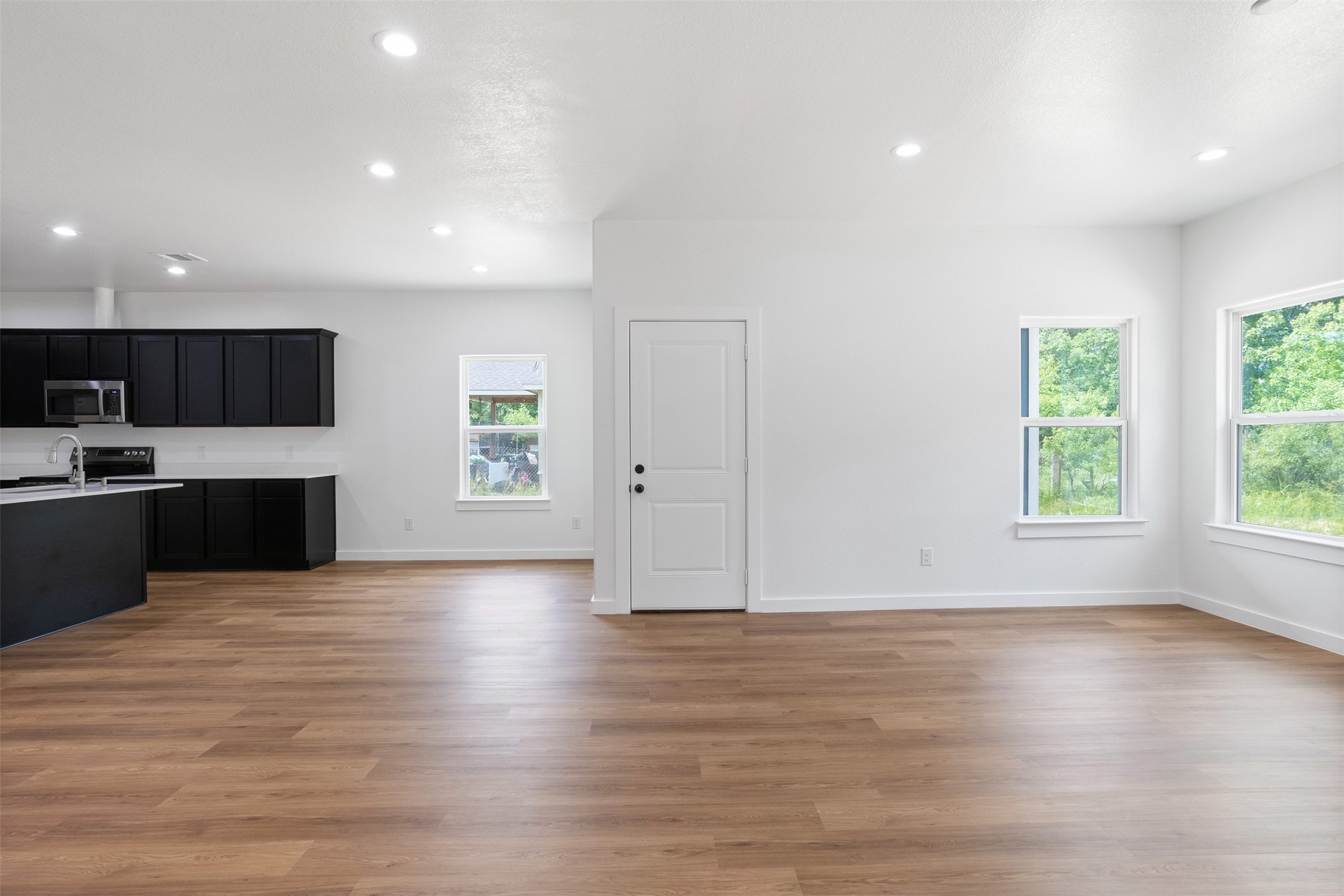 14390 Half Circle Splendora, TX 77372 - Photo 23 of 27 an empty room with wooden floor and windows