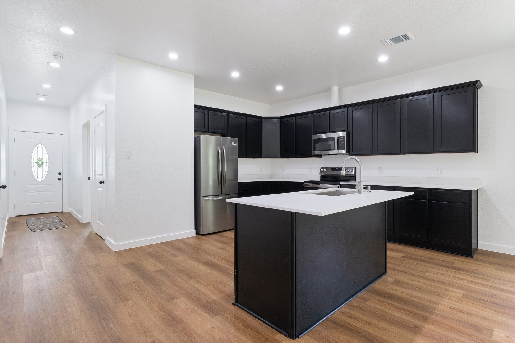 14390 Half Circle Splendora, TX 77372 - Photo 25 of 27 a kitchen with kitchen island stainless steel appliances a sink and a refrigerator