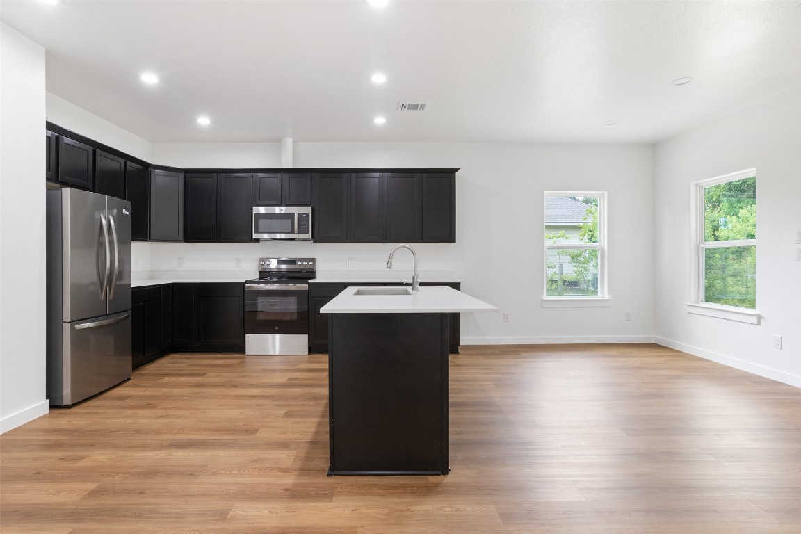14390 Half Circle Splendora, TX 77372 - Photo 26 of 27 a kitchen with a refrigerator and a sink