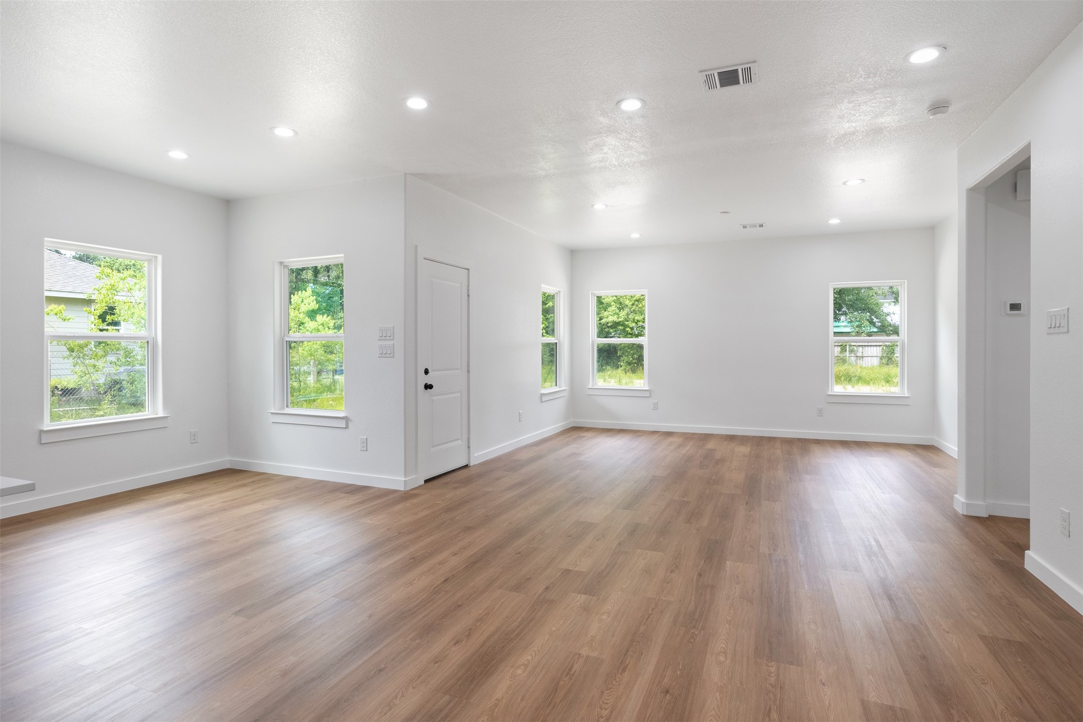 14390 Half Circle Splendora, TX 77372 - Photo 8 of 27 an empty room with wooden floor and windows