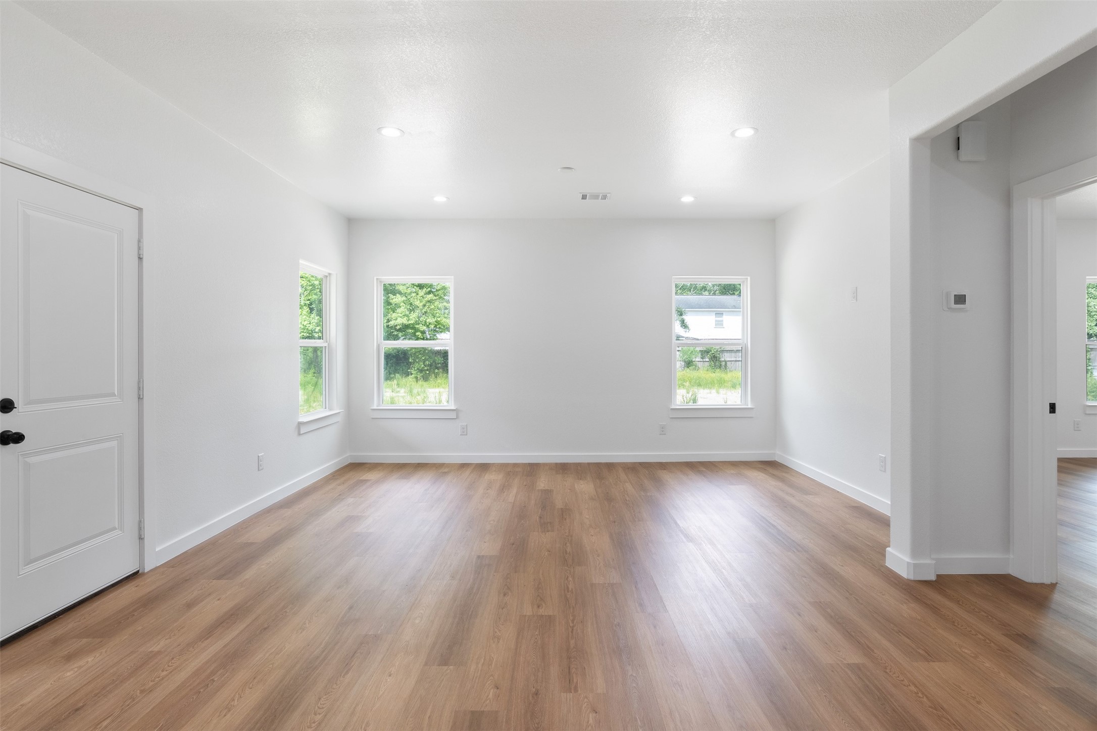 14390 Half Circle Splendora, TX 77372 - Photo 10 of 27 an empty room with wooden floor and windows