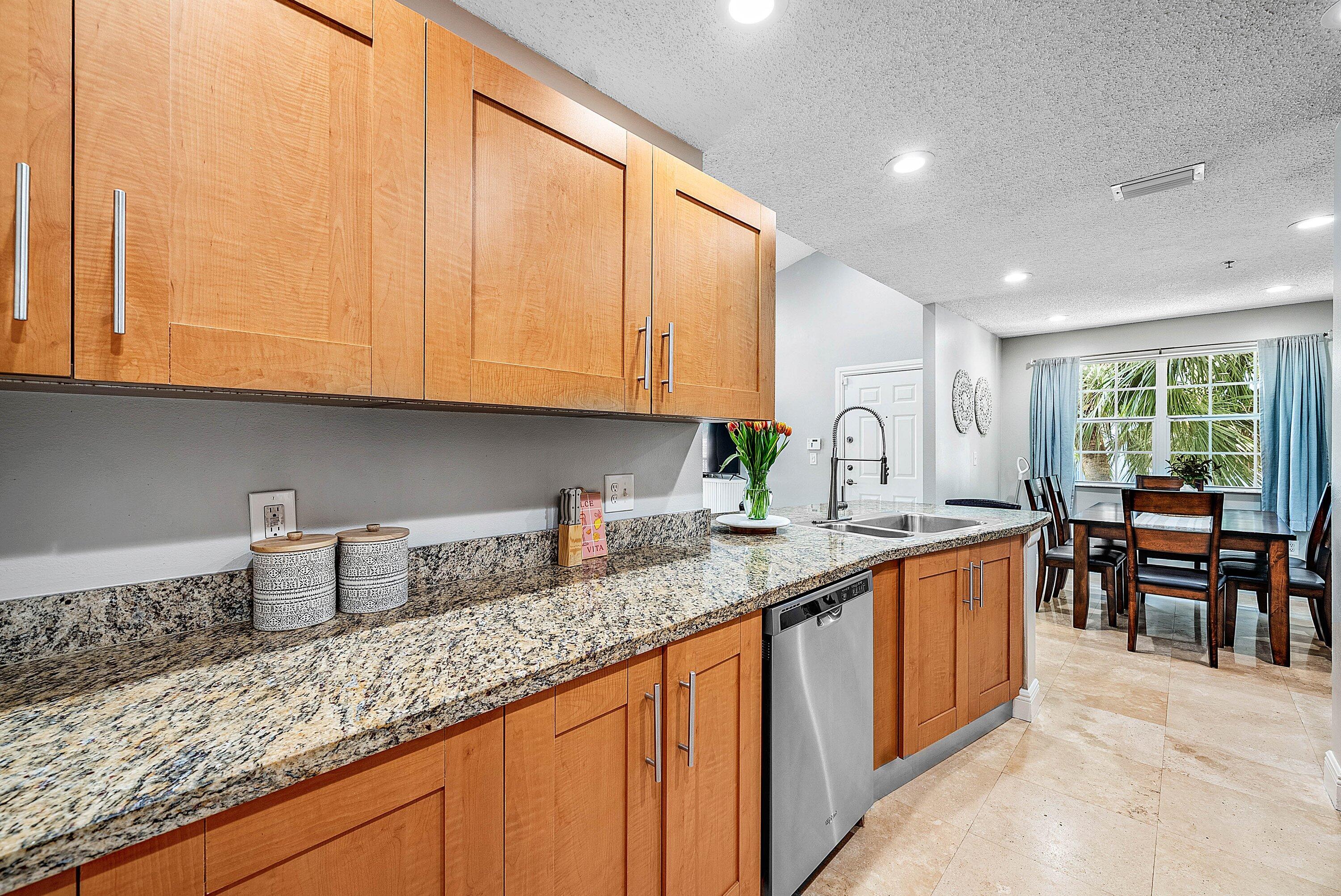 Undisclosed Address Boca Raton, FL 33496 - Photo 11 of 46 a kitchen with stainless steel appliances granite countertop a sink and cabinets