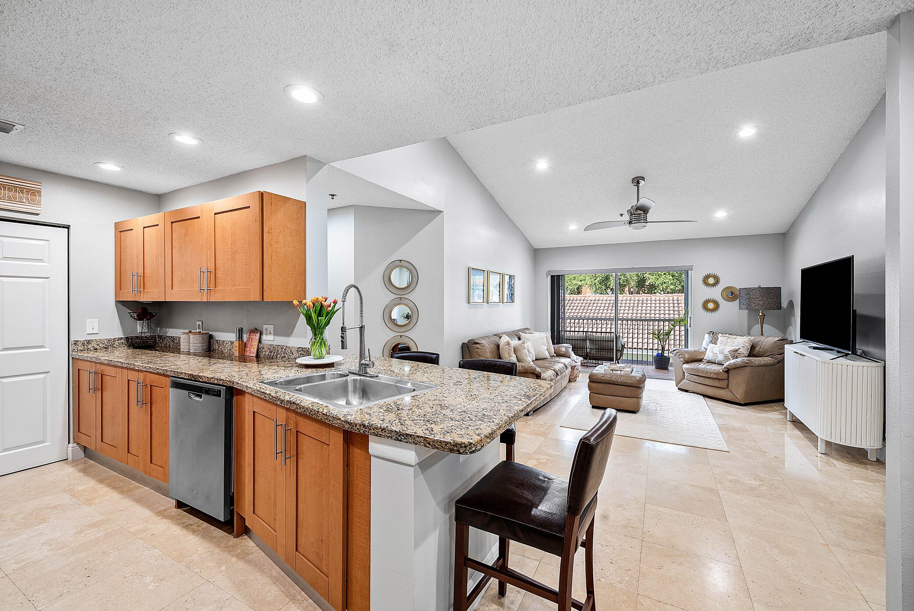 Undisclosed Address Boca Raton, FL 33496 - Photo 14 of 46 a large kitchen with kitchen island granite countertop lots of counter top space and stainless steel appliances