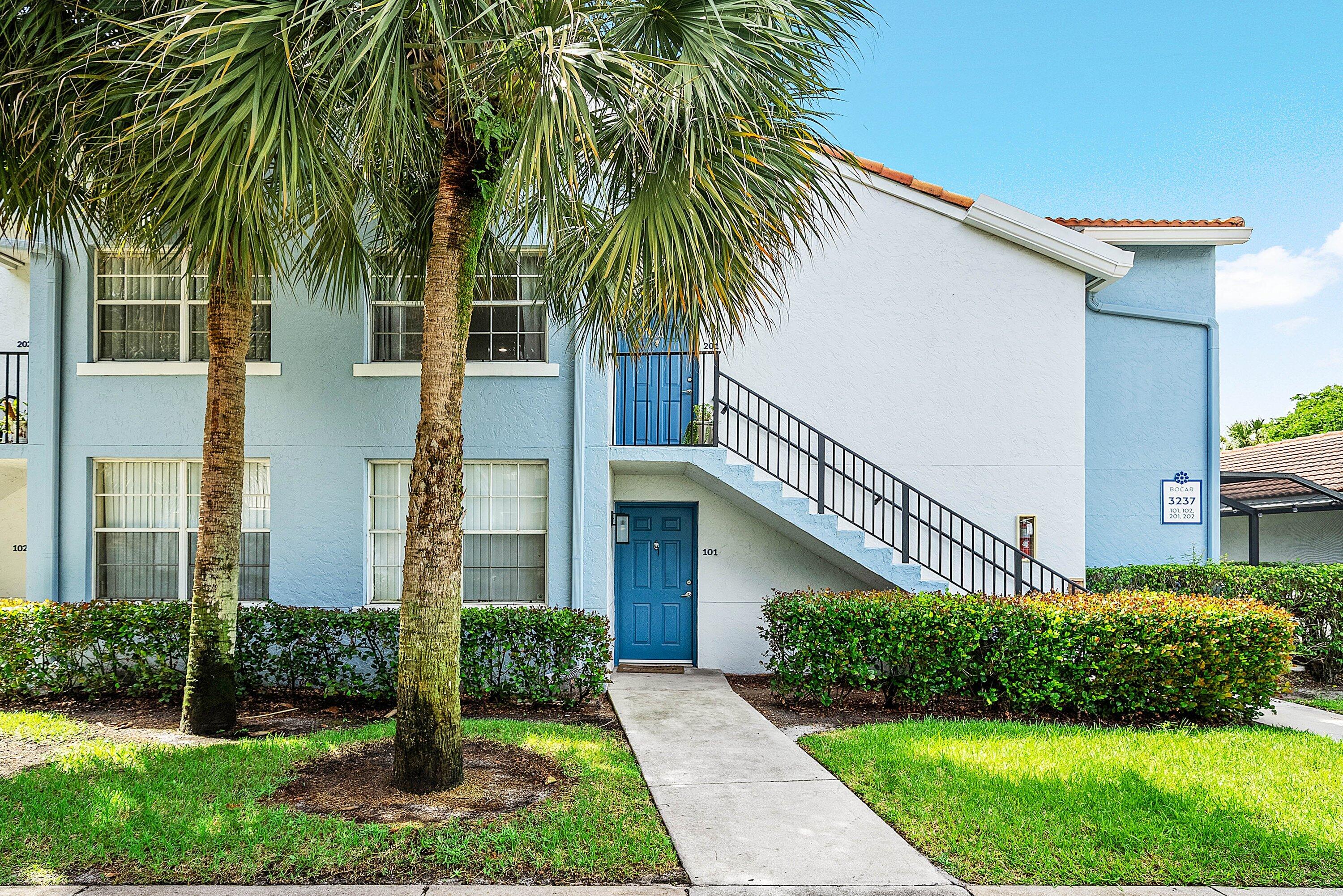 Undisclosed Address Boca Raton, FL 33496 - Photo 2 of 46 a front view of a house with a yard