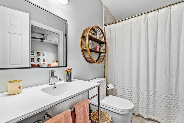 a bathroom with a toilet a sink and a mirror