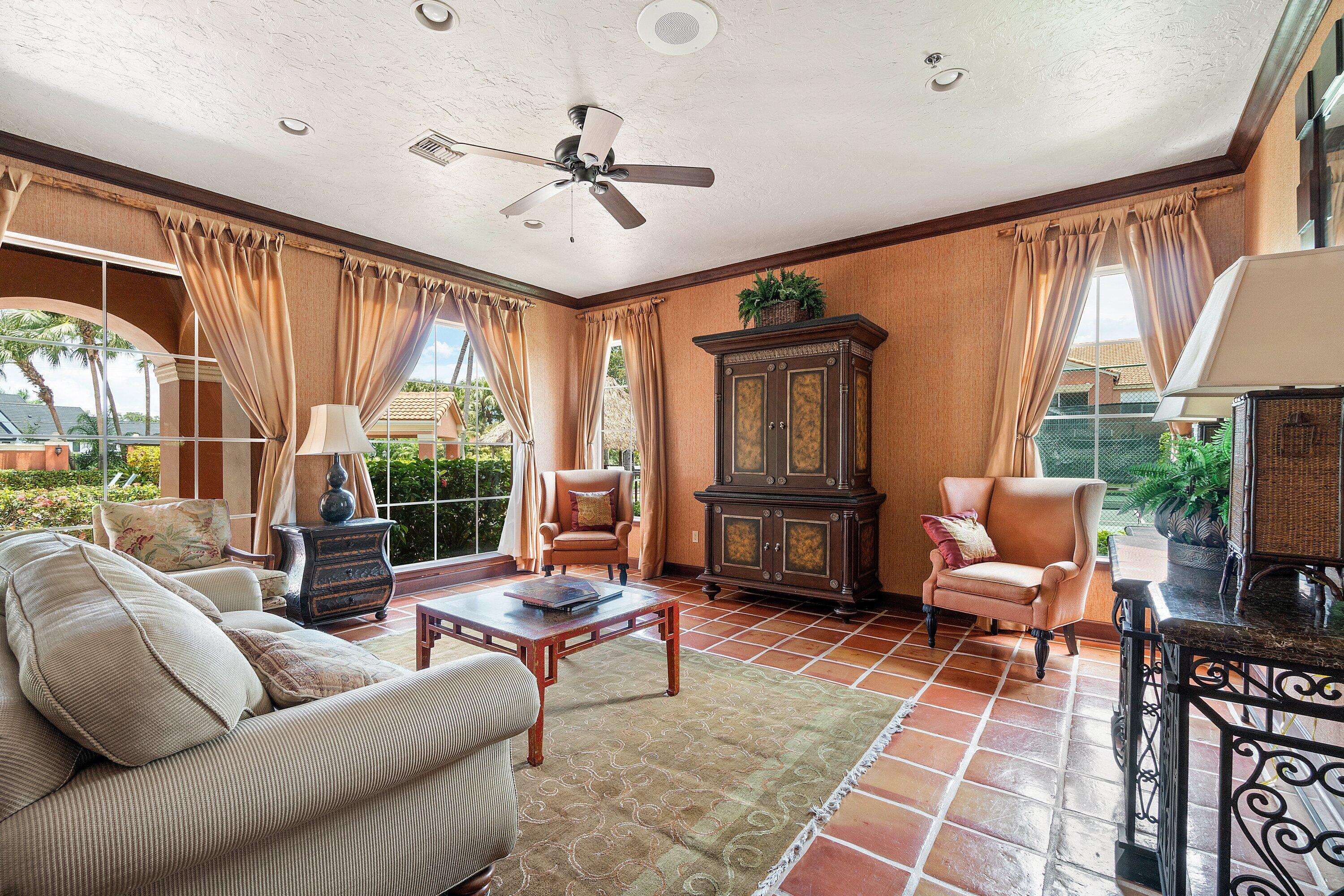 Undisclosed Address Boca Raton, FL 33496 - Photo 43 of 46 a living room with furniture a ceiling fan and a large window