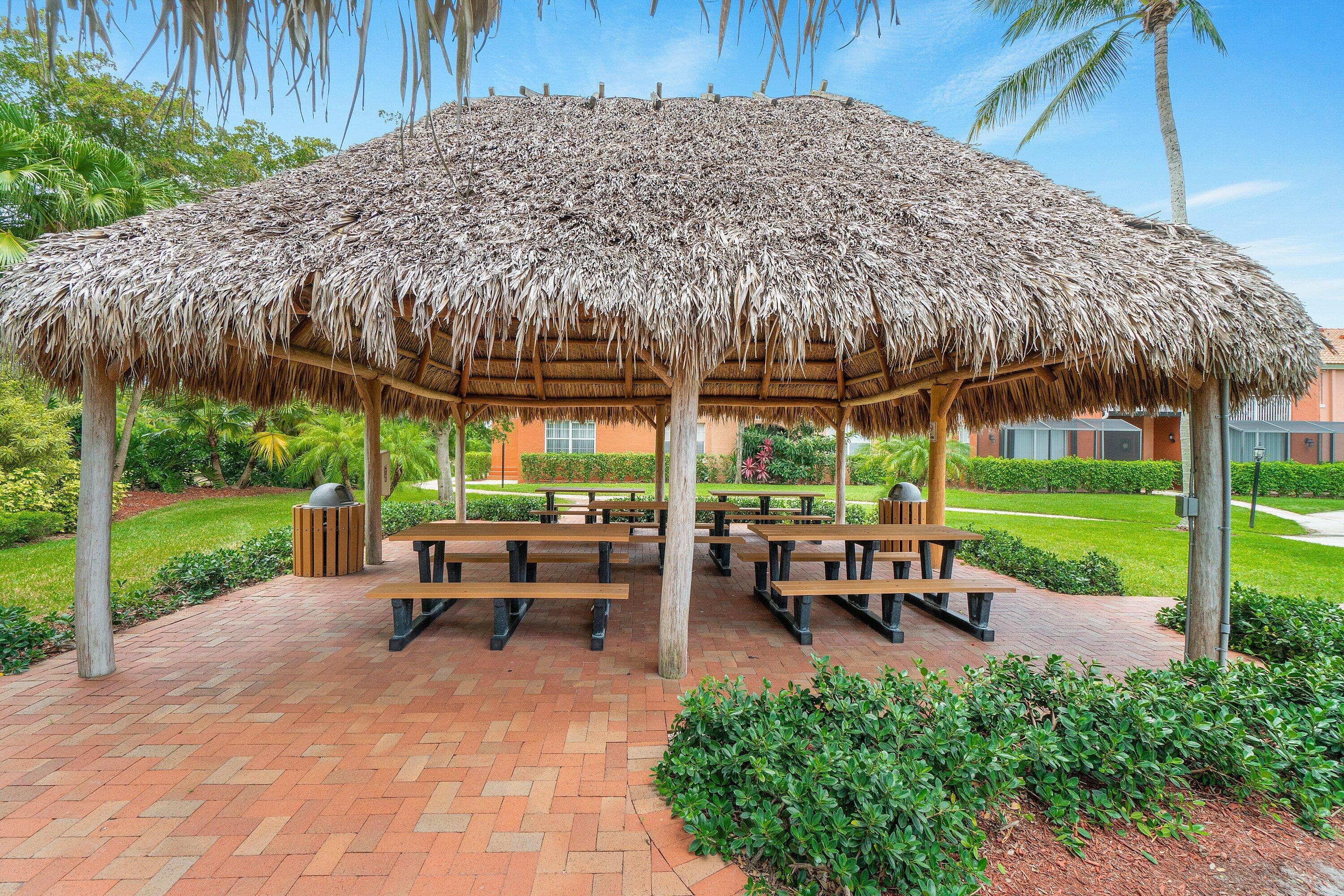 Undisclosed Address Boca Raton, FL 33496 - Photo 44 of 46 a view of a table and chairs under an umbrella