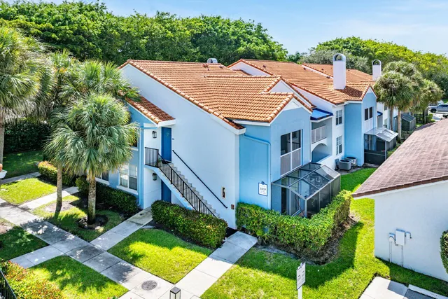 a aerial view of a house with swimming pool garden and patio