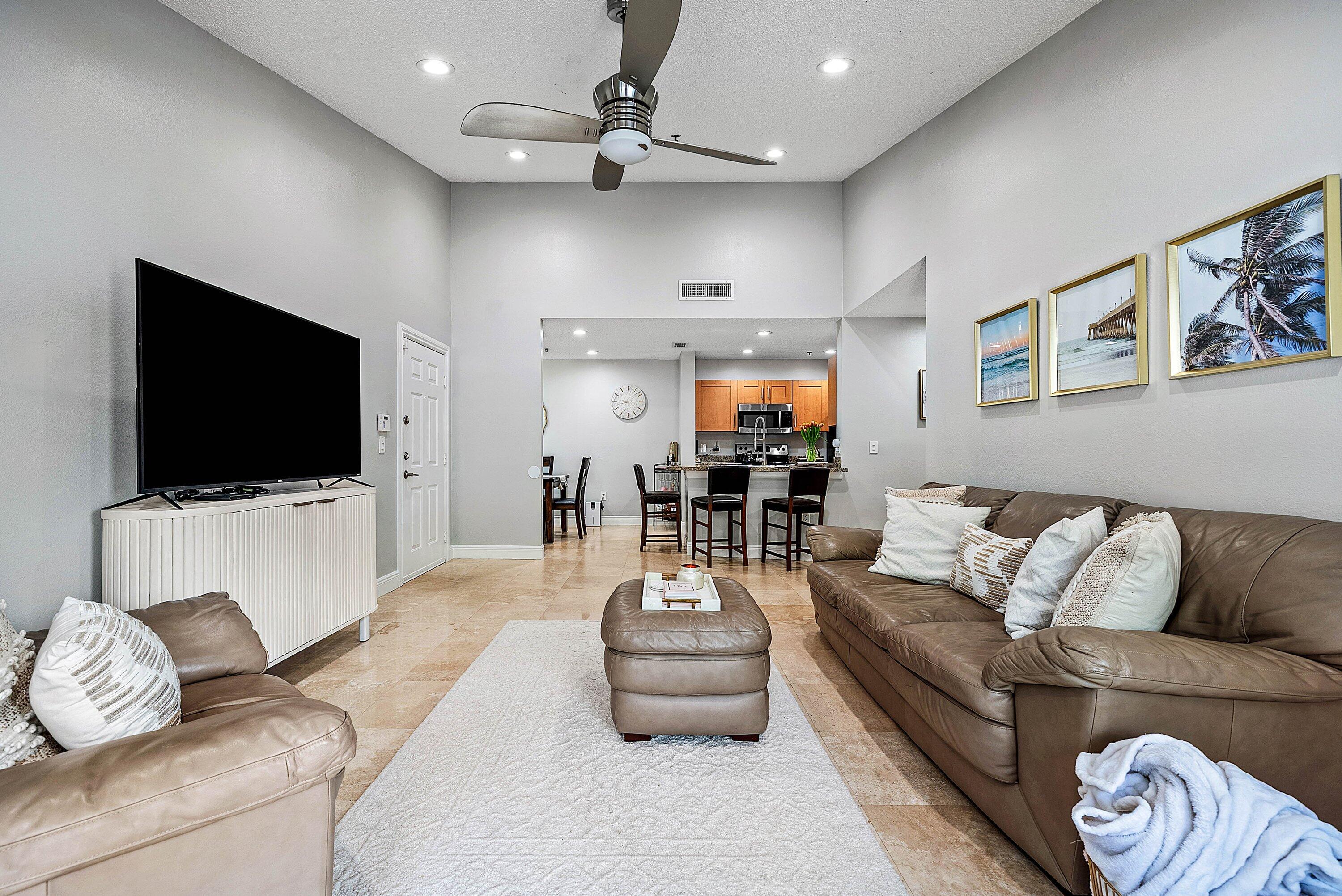 Undisclosed Address Boca Raton, FL 33496 - Photo 6 of 46 a living room with furniture and a flat screen tv