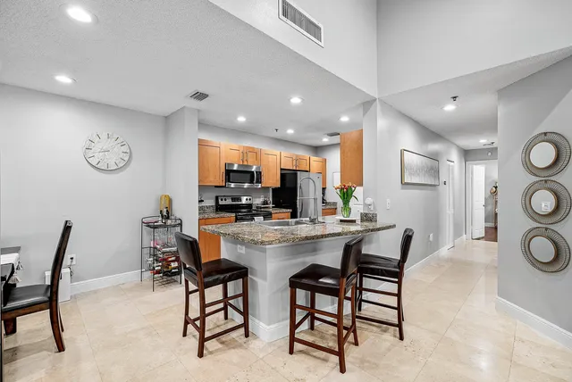 a view of a dining area with furniture and a large window
