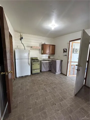 a kitchen with a refrigerator and a sink