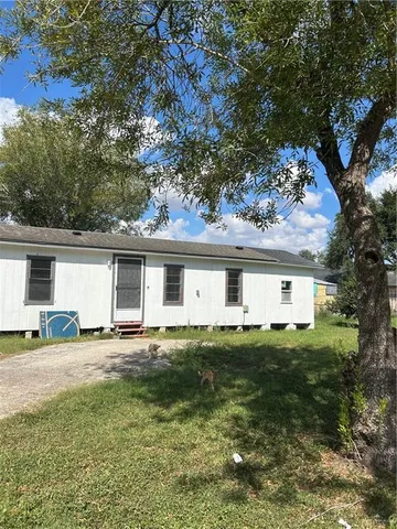 a house that has a tree in front of it