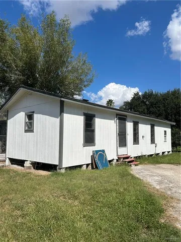 a view of a backyard with potted plants