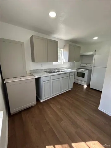 a kitchen with a sink and a refrigerator