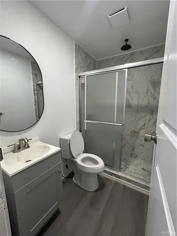 a bathroom with a sink toilet and shower