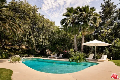 a view of a table and chairs under an umbrella