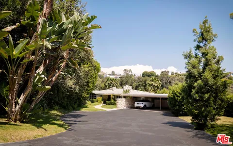 a view of a house with a yard and tree s