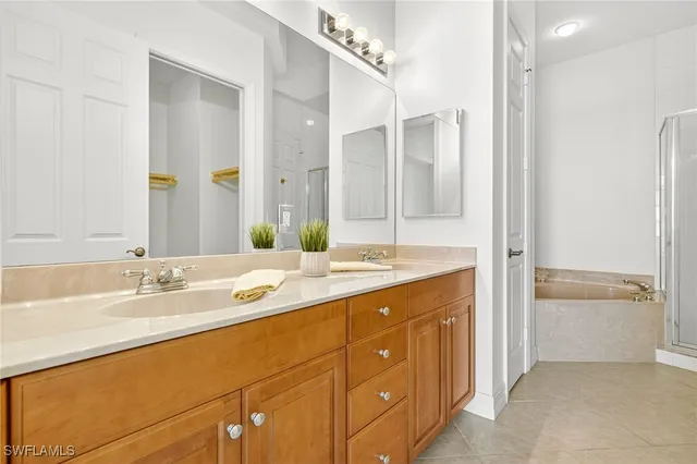 a spacious bathroom with a double vanity sink mirror double and shower
