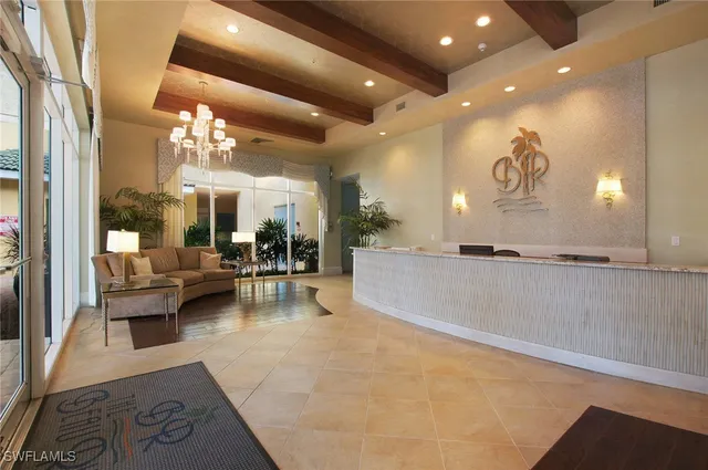 a living room with furniture a chandelier and a large window