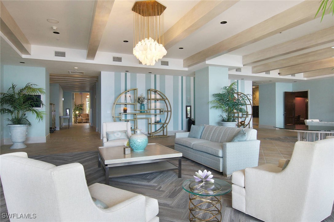2797 First Street, Unit 2004 Fort Myers, FL 33916 - Photo 29 of 41 a living room with furniture a chandelier and a dining table
