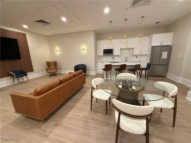 a living room with furniture pool table and a flat screen tv