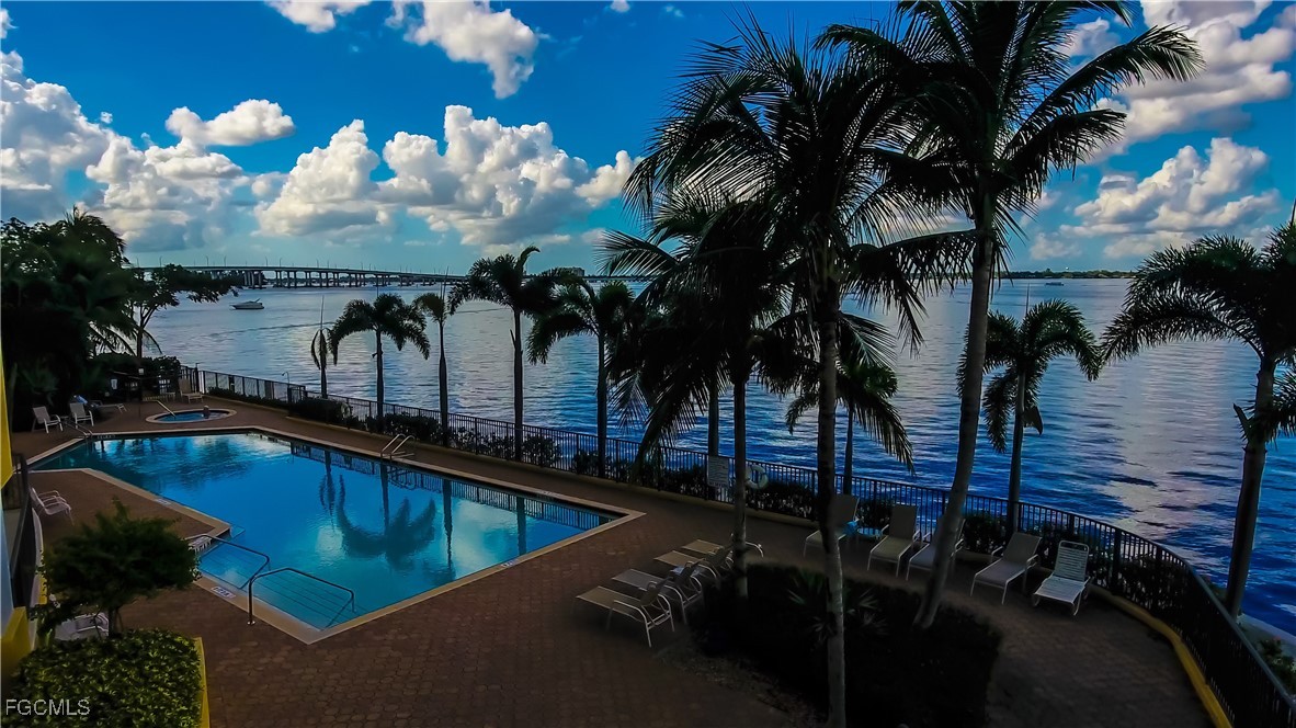 2797 First Street, Unit 2004 Fort Myers, FL 33916 - Photo 41 of 41 a view of a swimming pool with a table and chairs