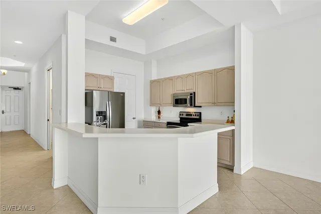 a kitchen with stainless steel appliances a refrigerator sink and microwave
