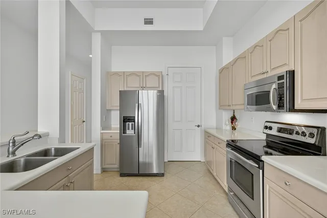 a kitchen with stainless steel appliances granite countertop a refrigerator and a sink