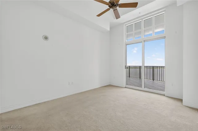 an empty room with a ceiling fan