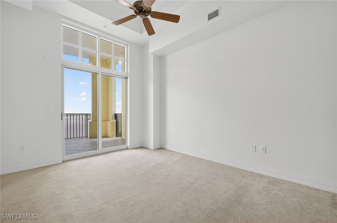 2797 First Street, Unit 2004 Fort Myers, FL 33916 - Photo 10 of 41 an empty room with chandelier fan and windows