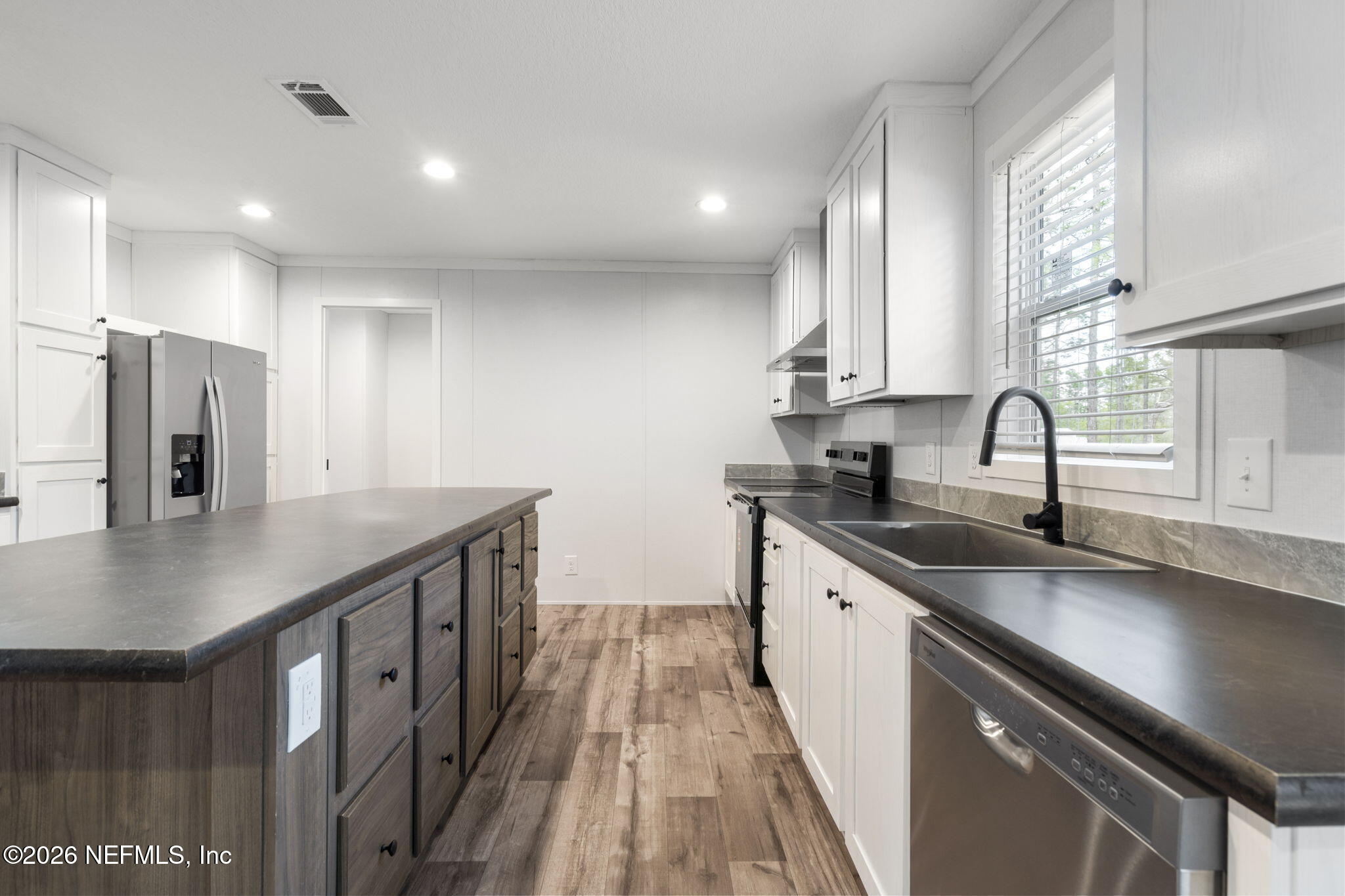 110 Slipper Way Hawthorne, FL 32640 - Photo 12 of 42 a kitchen with a sink stove and cabinets