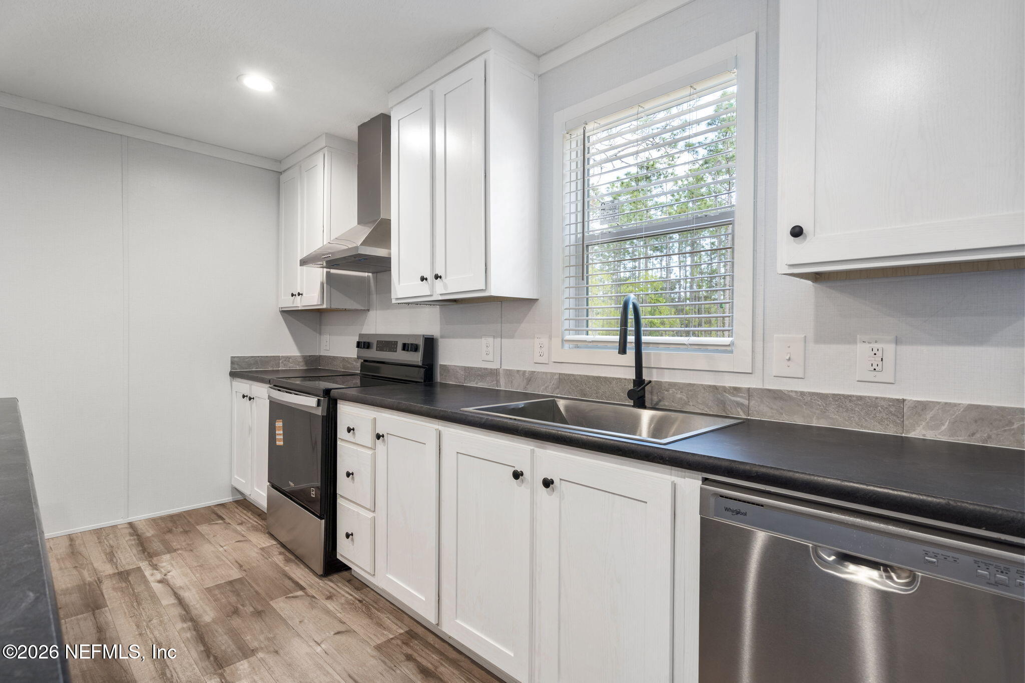 110 Slipper Way Hawthorne, FL 32640 - Photo 13 of 42 a kitchen with granite countertop a sink and white cabinets