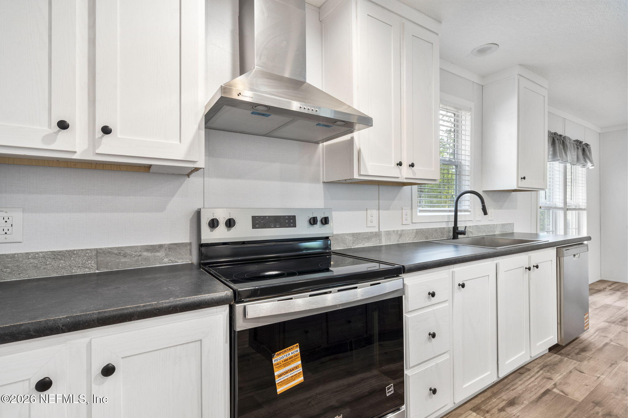 110 Slipper Way Hawthorne, FL 32640 - Photo 15 of 42 a kitchen with granite countertop white cabinets and a stove