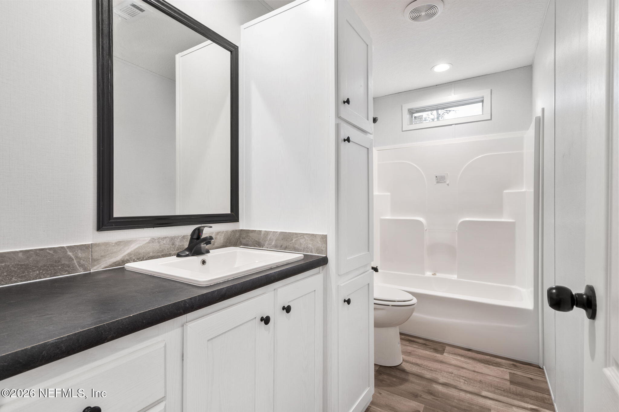 110 Slipper Way Hawthorne, FL 32640 - Photo 19 of 42 a bathroom with a sink a toilet and shower