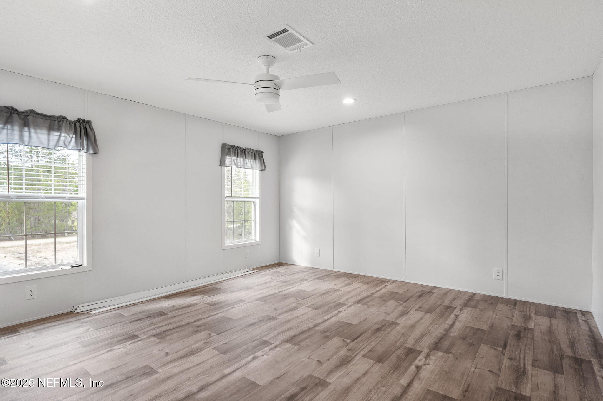 110 Slipper Way Hawthorne, FL 32640 - Photo 21 of 42 wooden floor in an empty room with a window