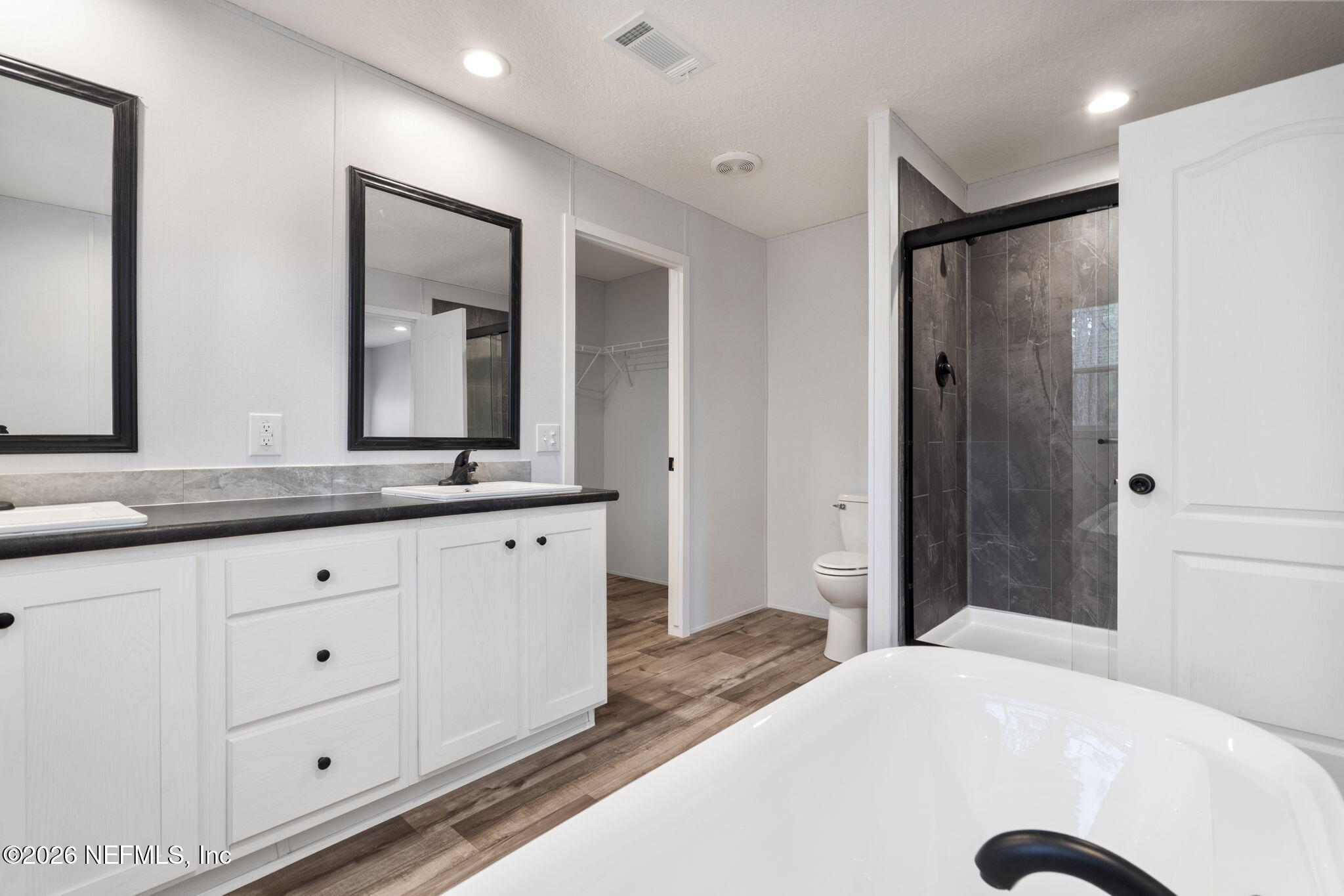 110 Slipper Way Hawthorne, FL 32640 - Photo 23 of 42 a en suite bathroom with a double vanity sink and a mirror