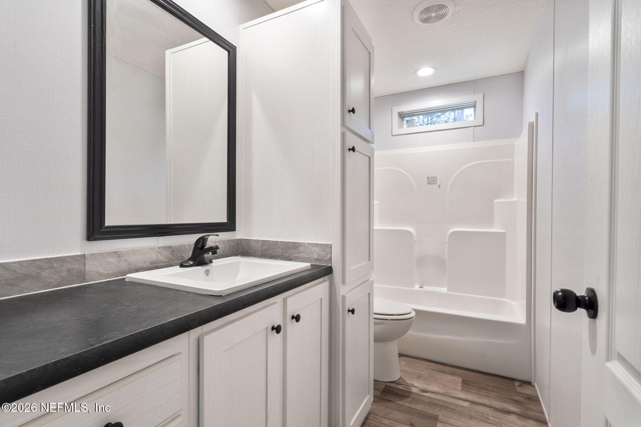 110 Slipper Way Hawthorne, FL 32640 - Photo 29 of 42 a bathroom with a granite countertop sink and a mirror