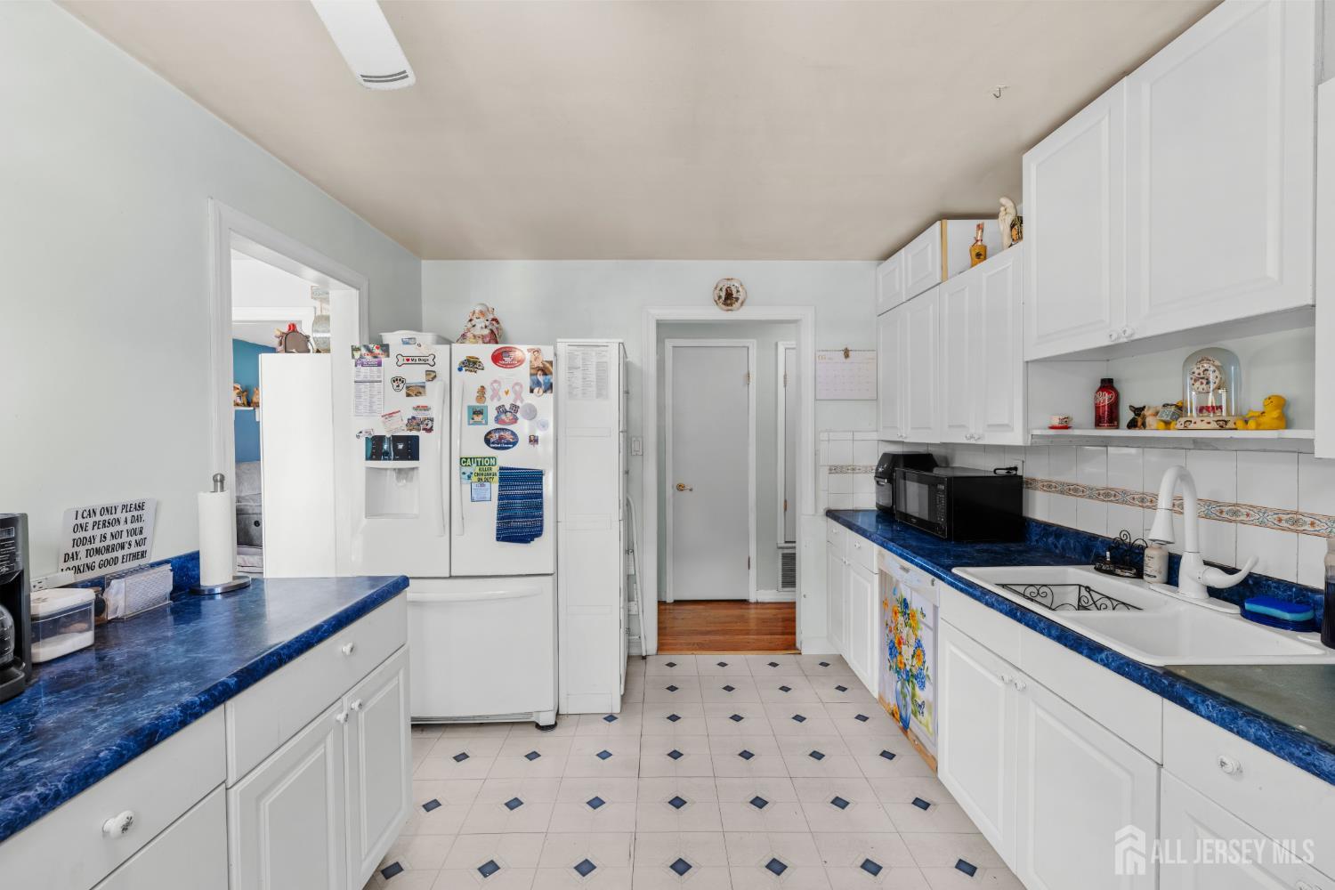 245 4th Street Dunellen, NJ 08812 - Photo 10 of 27 a kitchen with granite countertop a refrigerator and a sink