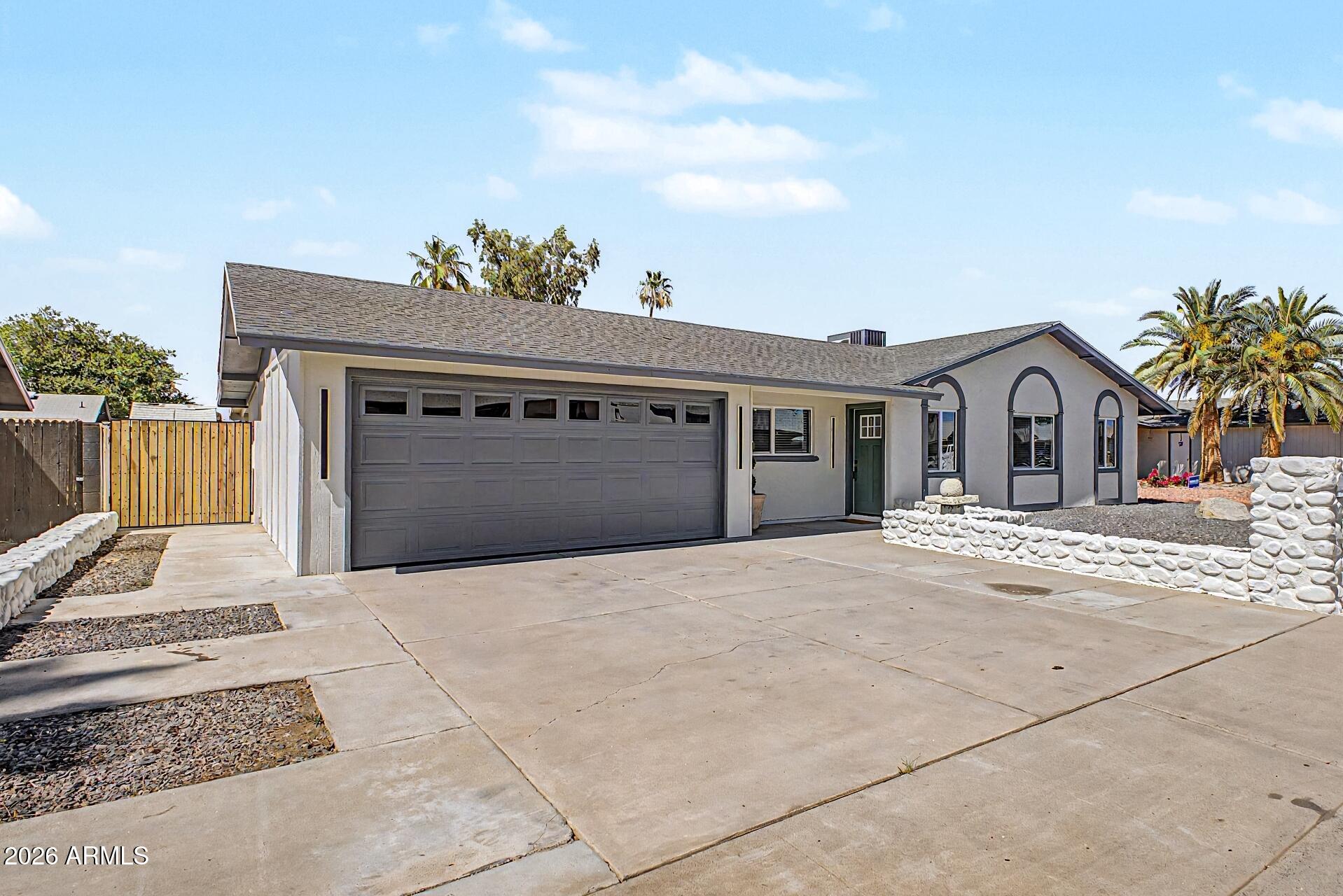 5232 West Hearn Road Glendale, AZ 85306 - Photo 29 of 32 a front view of a house with a yard and garage