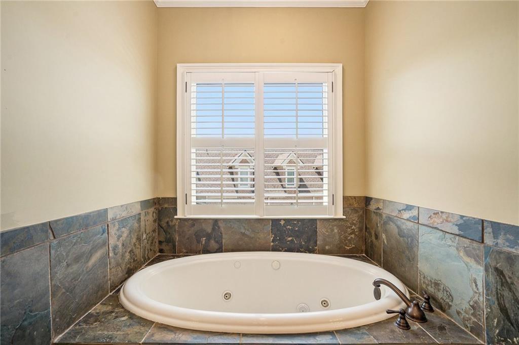 2317 Crimson King Drive Braselton, GA 30517 - Photo 52 of 66 a white bath tub sitting in a bathroom next to a window
