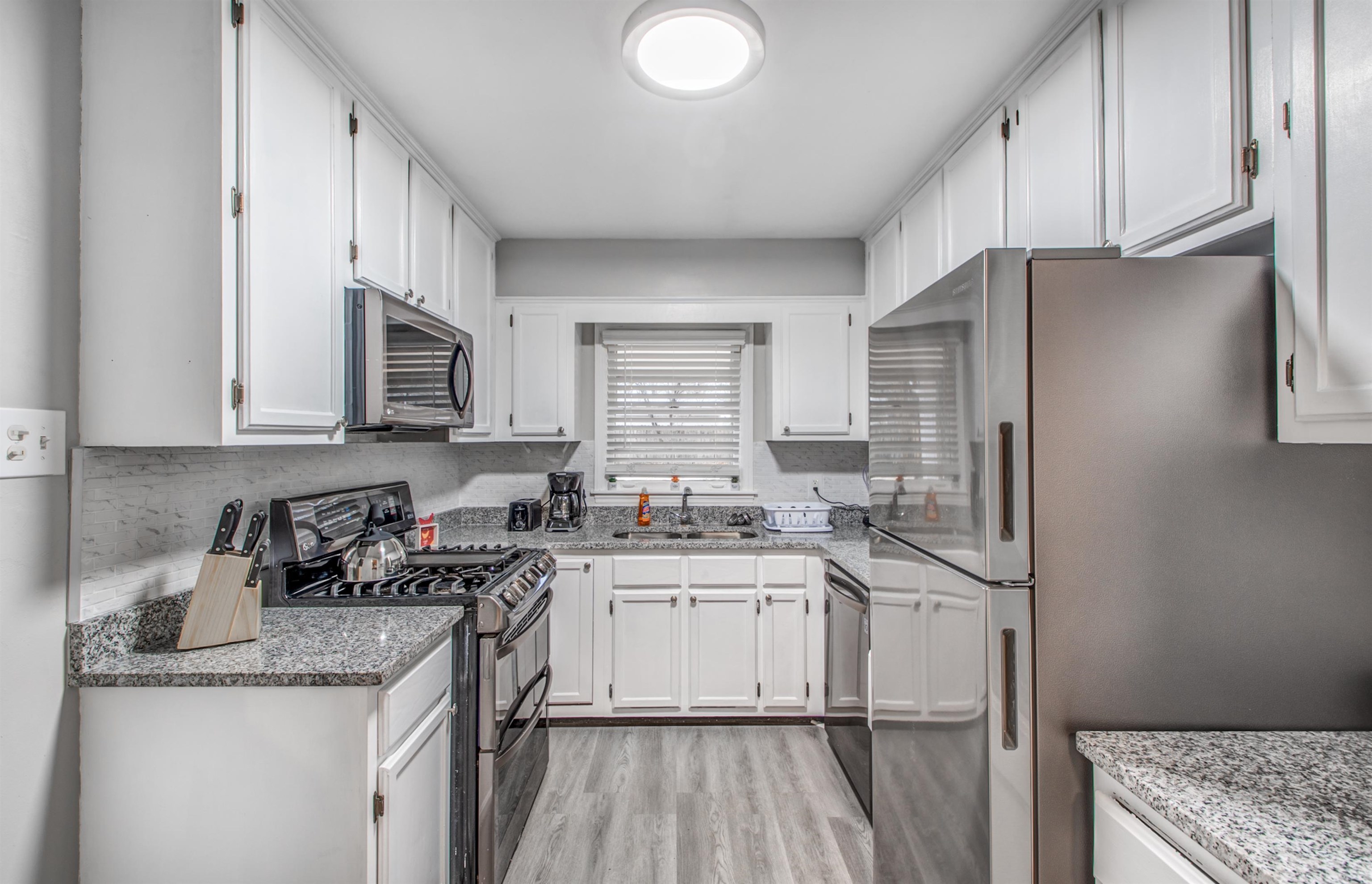 1160 West Perkins Road Memphis, TN 38117 - Photo 8 of 19 a kitchen with stainless steel appliances granite countertop a sink stove and refrigerator