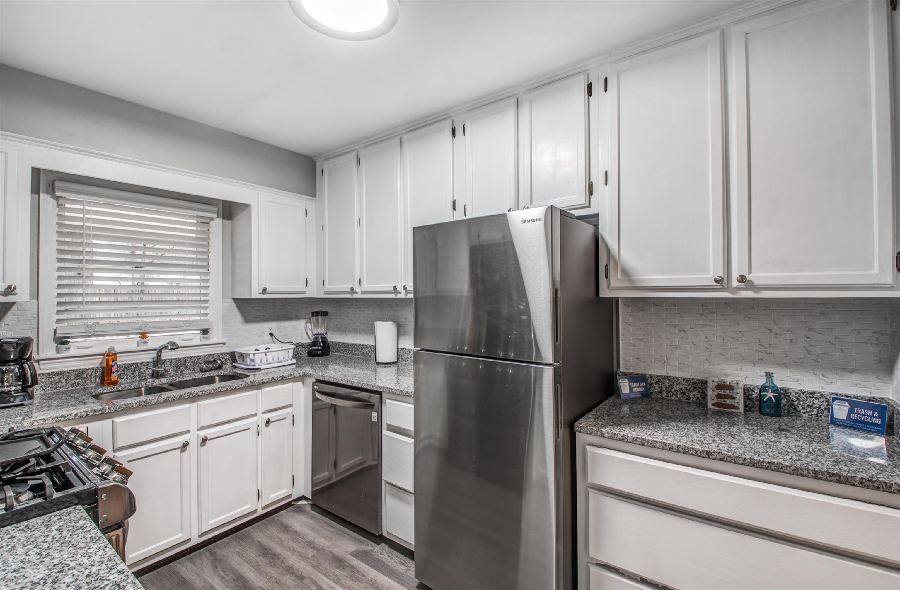 1160 West Perkins Road Memphis, TN 38117 - Photo 9 of 19 a kitchen with a refrigerator sink stove and cabinets