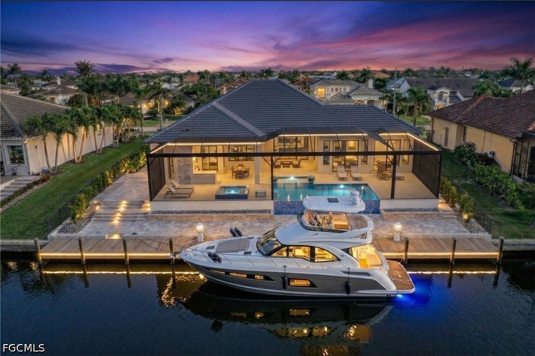 1524 Southwest 57th Street Cape Coral, FL 33914 - Photo 2 of 45 a view of a swimming pool with lounge chair