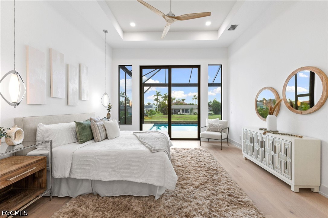 1524 Southwest 57th Street Cape Coral, FL 33914 - Photo 25 of 45 a bedroom with a bed a mirror and a large window with the outer view