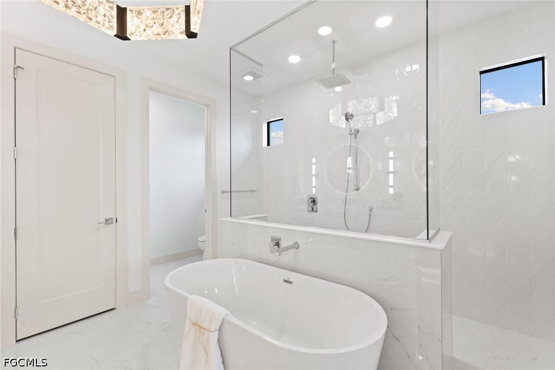 1524 Southwest 57th Street Cape Coral, FL 33914 - Photo 27 of 45 a bathroom with a bathtub a shower a sink and a mirror