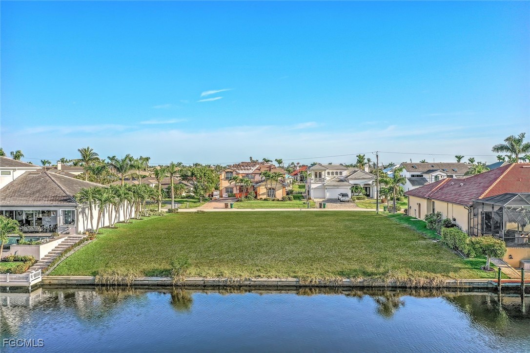 1524 Southwest 57th Street Cape Coral, FL 33914 - Photo 33 of 45 a view of a lake with houses in the background